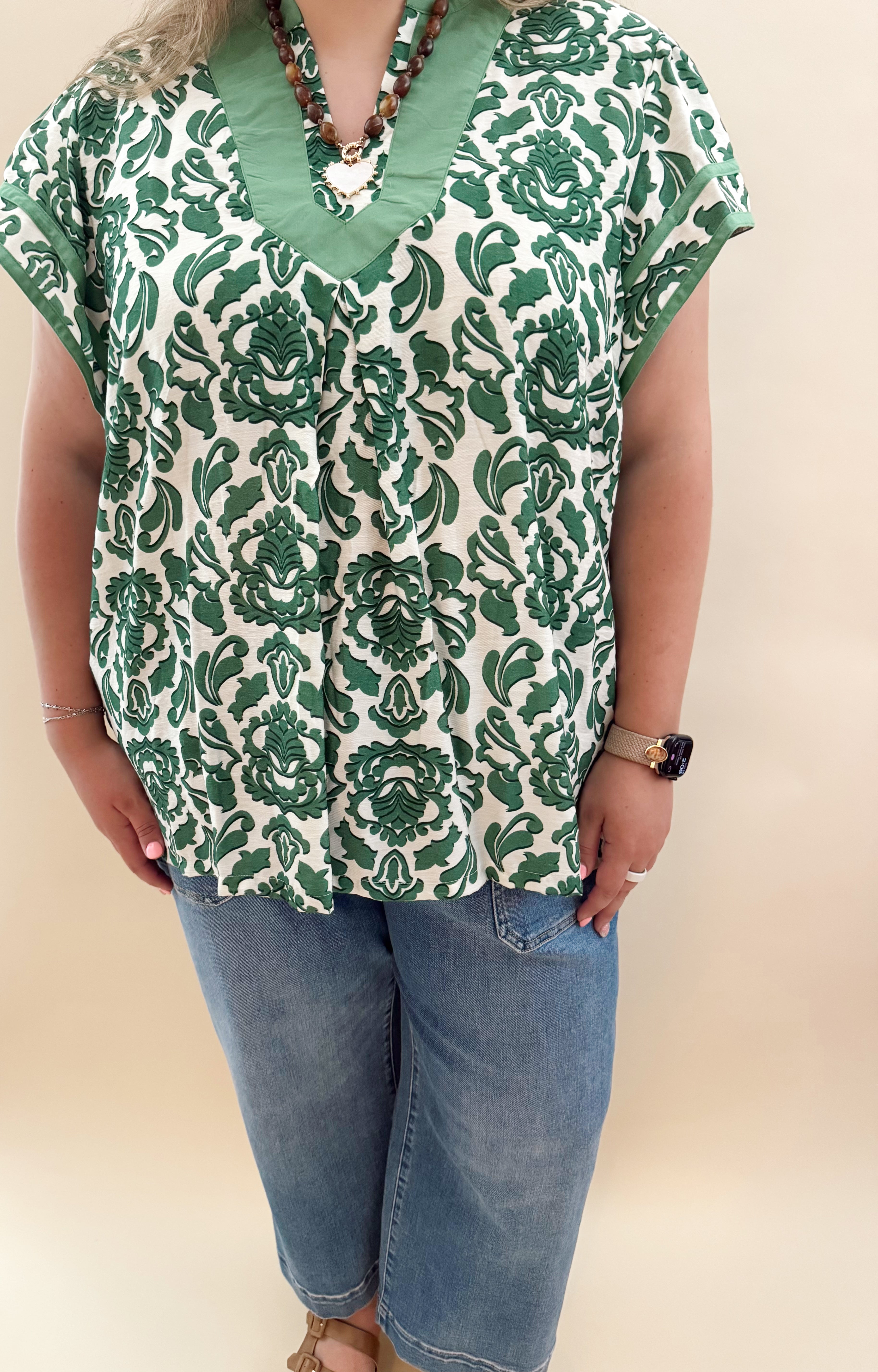 Green and white patterned blouse