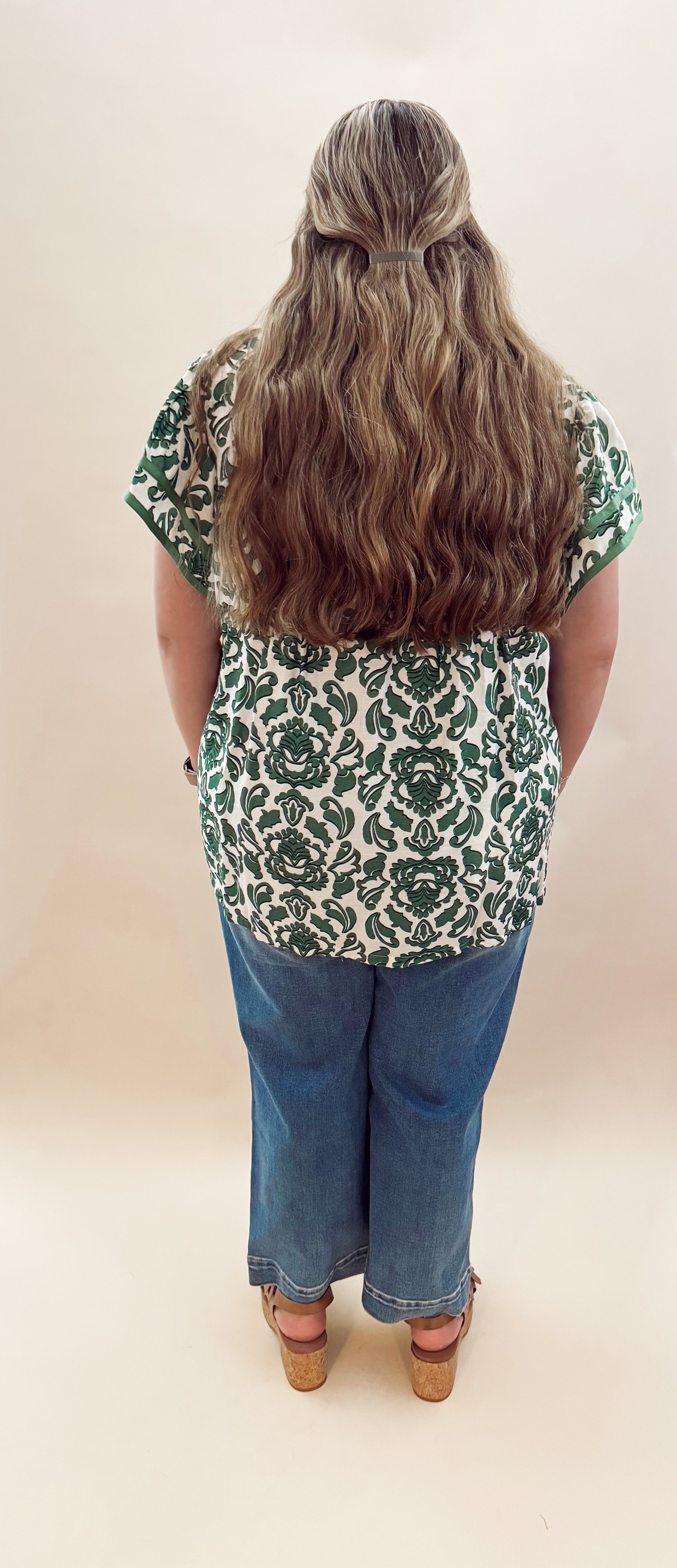 Green and white patterned blouse